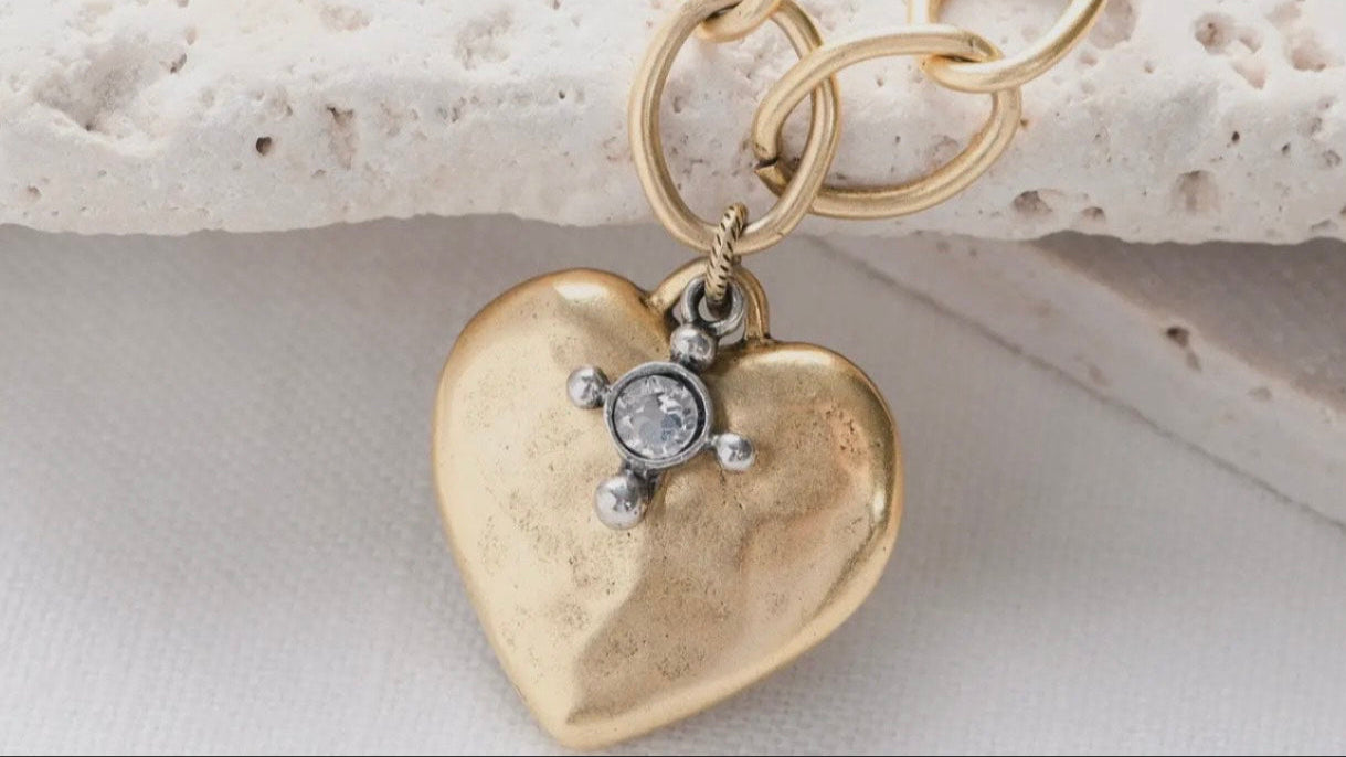 Gold heart-shaped pendant necklace with a small round charm 